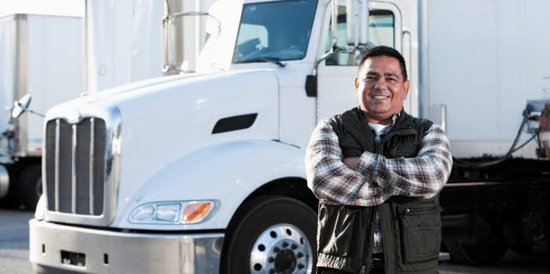 Driver at the trailer handling paperwork